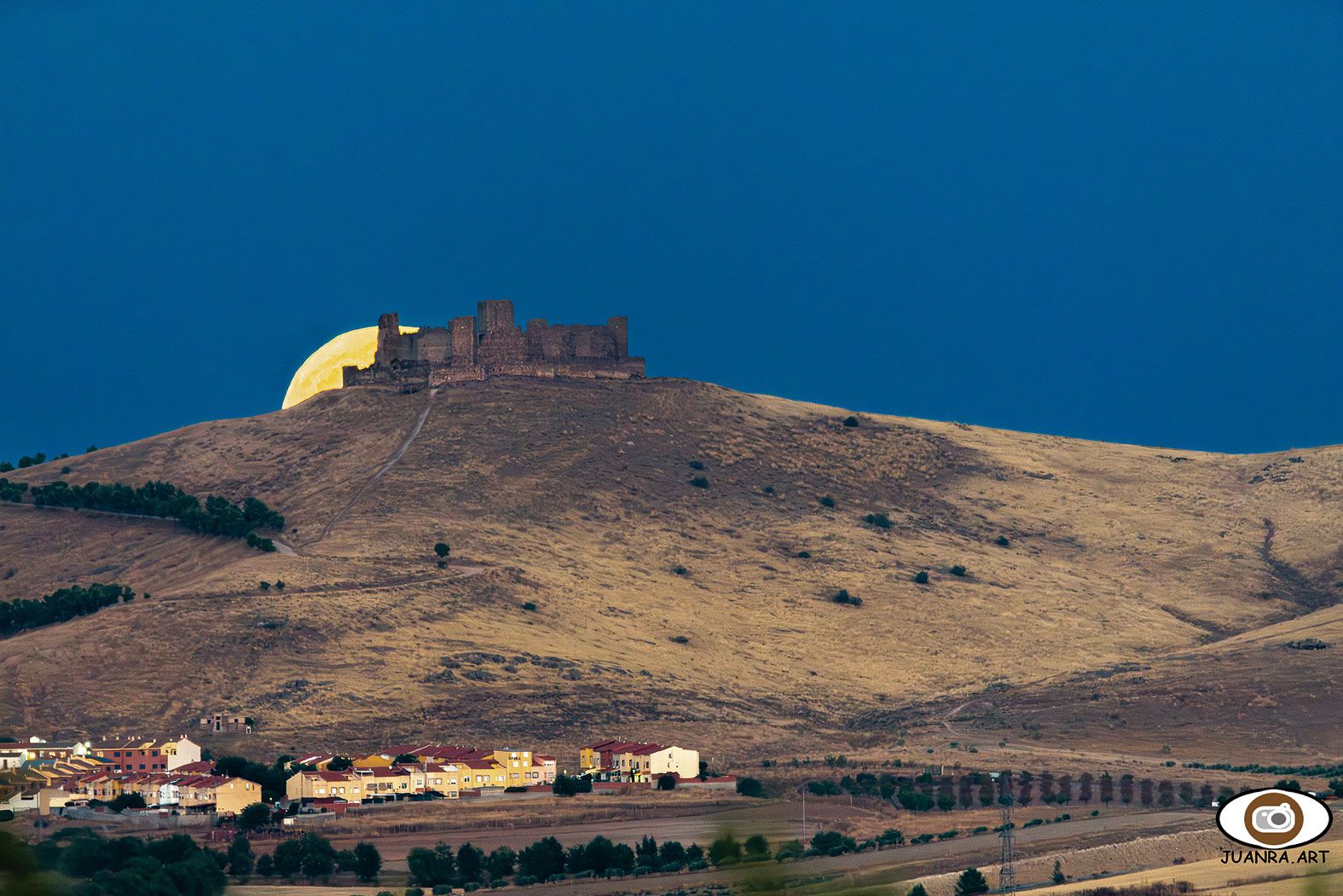 Luna saliendo tras el castillo de Almonacid (Toledo)